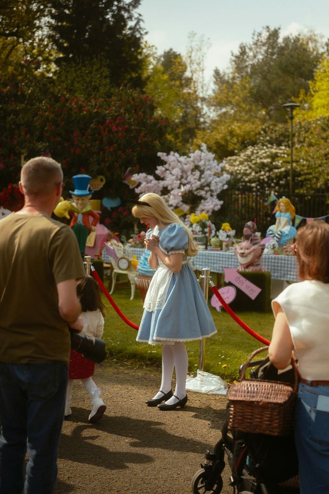 A costumed storybook character greeting families at a party