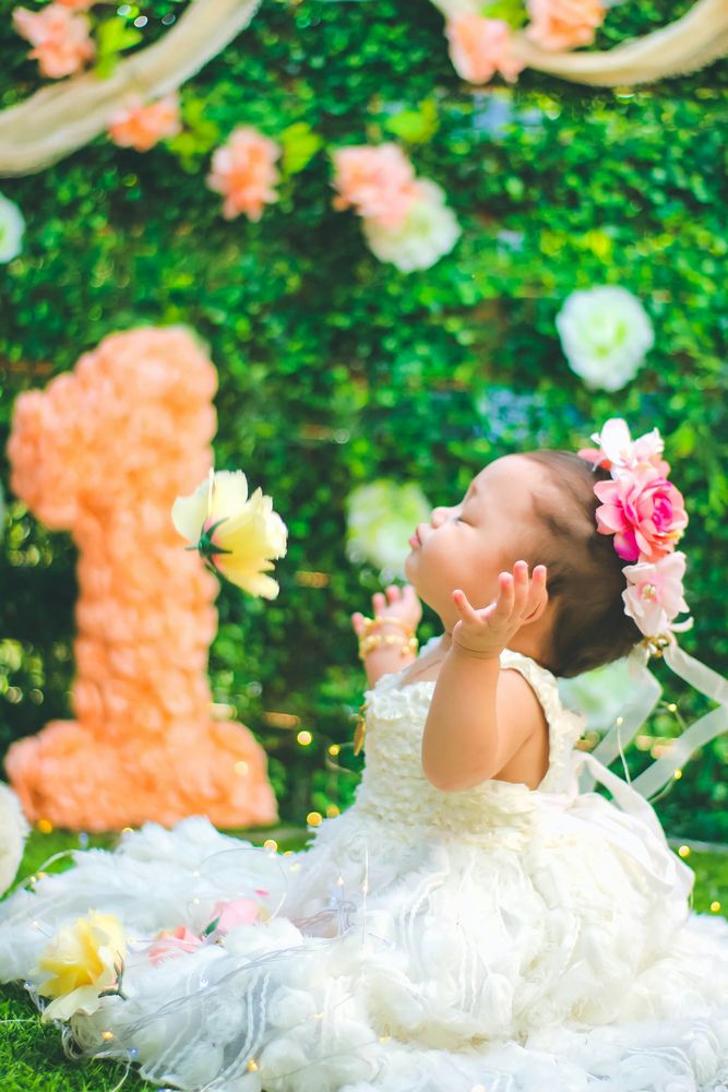 A baby in a flower crown photographed at her first birthday